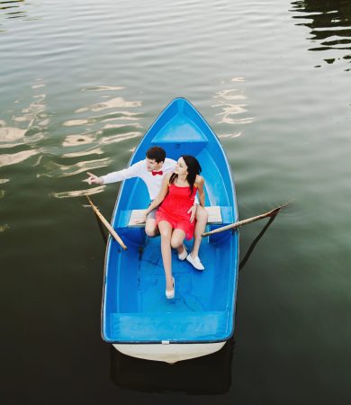 young beautiful couple sitting in a boat